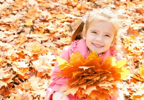 Little Girl Playing with Leaves